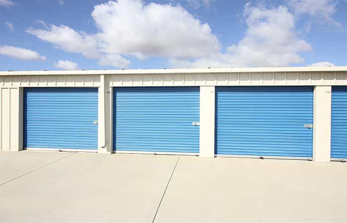 Large drive-up storage units with roll-up doors.