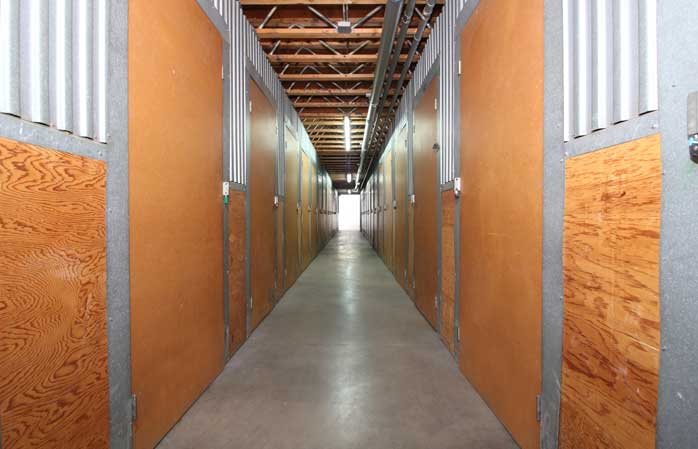 Small indoor storage units with swing doors.